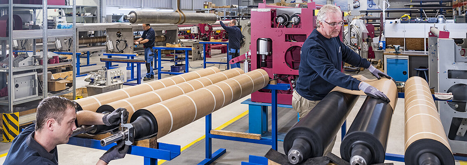 Two men working on different rolls